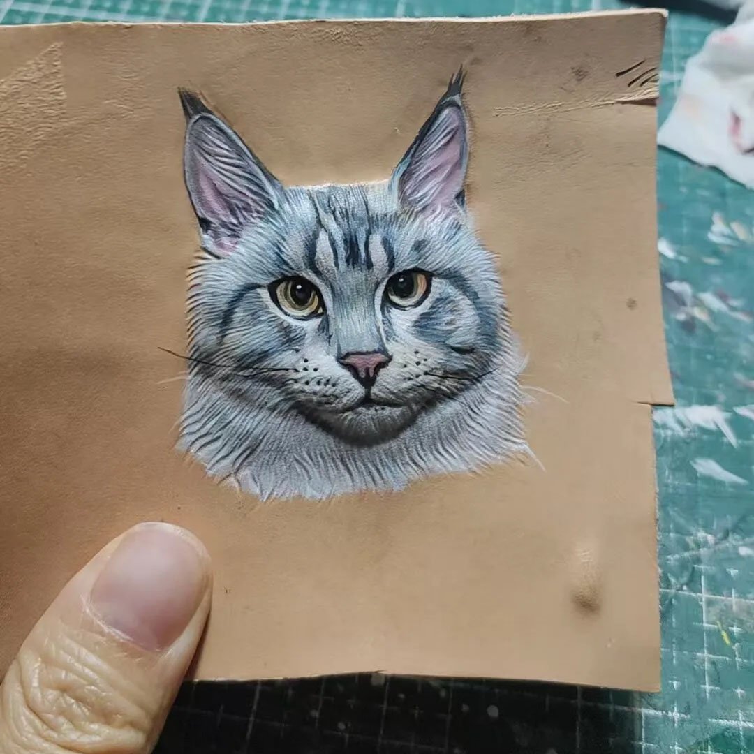 Partially painted 3D hand carved solid leather cat portrait blank, handmade Maine Coon leather carving showing detailed hand painting texture