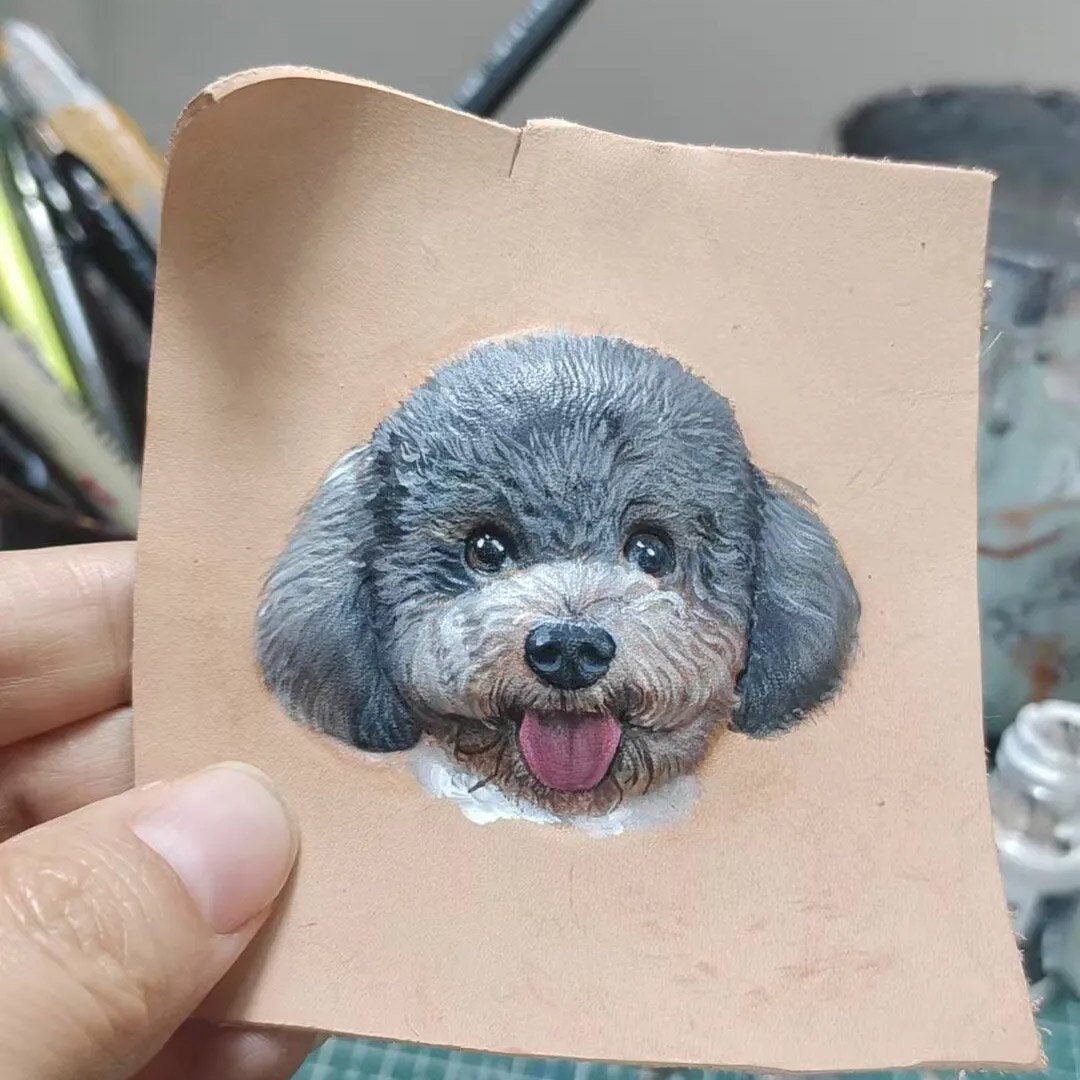 Partially painted 3D hand carved solid leather pet portrait blank, handmade dog carving showing detailed fur coloring work in progress