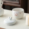 Detachable heart knob lid of small ceramic pet urn, embossed pink paw print detail for custom photo cat ashes memorial jar